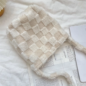 Detail of plush checkerboard trapper hat with soft faux fur texture and ear flaps