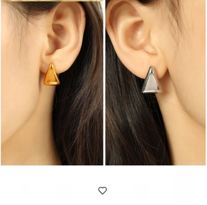 Detailed comparison of gold and silver geometric triangle stud earrings on ear