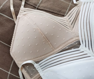 Detail of breathable mesh bra fabric with polka dot texture and thin shoulder straps