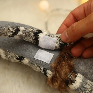 Grey felt Christmas gnome decoration with fuzzy brown fur and velcro strap detail
