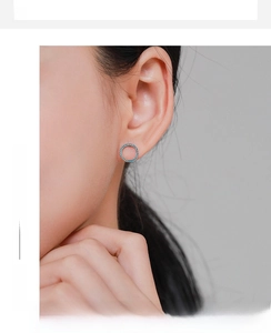 Close-up of minimalist S925 silver hoop earrings featuring blue turquoise pave setting