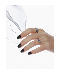 Detail of irregular texture silver ring and purple zircon stone ring on hand