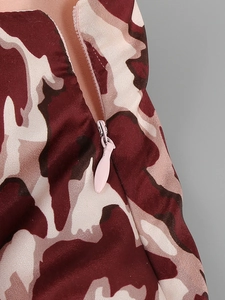 Macro detail of red-brown camouflage dress with a functional pink zipper fastening