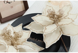 Detail of cream poinsettia with gold glitter petals for Christmas decor