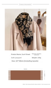 Detail of leopard jacquard pattern on thick faux cashmere scarf with black fringe tassels
