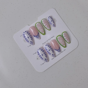 Detail of semi-handmade press-on nails with blue floral and 3D flower designs