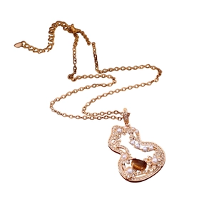 Vintage rose gold gourd necklace with tiger eye stone and pearls on white background