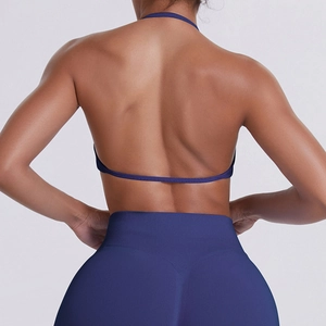 Detail of cross-back halter sports bra and high-waist leggings in navy blue fabric