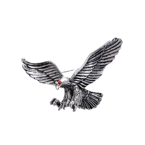Vintage silver eagle brooch with red rhinestone eyes and detailed feather texture for suits