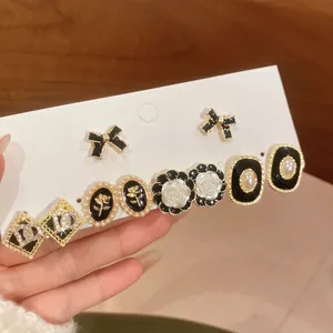 Luxury 6-pair gold and black earring set with pearls, floral, and geometric studs