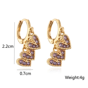 Detail view of gold earrings with three purple zircon hearts and size measurements