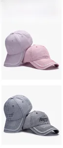 Detail of four washed denim baseball caps with lace brim and custom side embroidery
