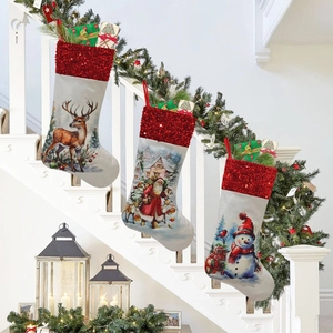 Three festive Christmas stockings with reindeer and Santa hanging on white staircase