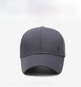 Close-up of a dark grey twill baseball cap with decorative brim stitching and metal logo