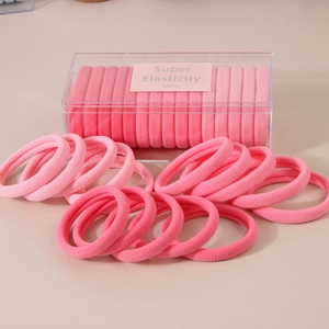 Pink high elasticity hair ties set in a transparent acrylic box with macro fabric details