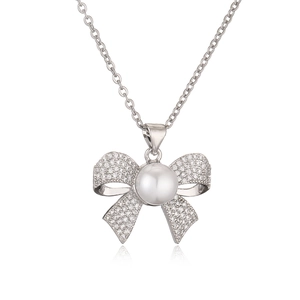 Elegant 18K gold-plated necklace featuring a zircon bow pendant and a white pearl