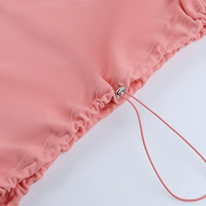 Detail of pink hoodie featuring adjustable elastic drawstring and silver metal toggle