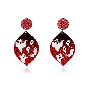 Macro shot of red glitter teardrop earrings with white ghost prints for Halloween