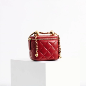 Detail of red quilted leather mini vanity case with golden ball chain adjustment