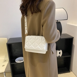 Chic white quilted crossbody bag for women with a patterned wide shoulder strap