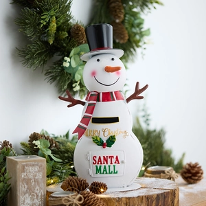 Christmas snowman mailbox metal decoration with red scarf on rustic wooden base with lights