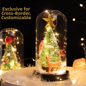 Illuminated glass dome featuring a mini Christmas tree and deer with warm LED lights