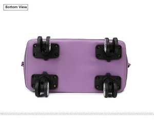 Detail of four black double spinner wheels on a purple waterproof travel bag base