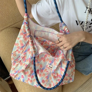 Detail view showing large capacity interior and tulip print of the floral tote bag