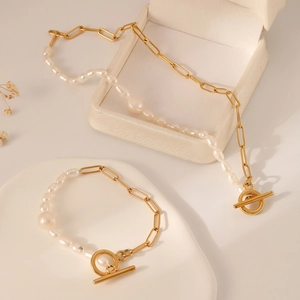 Detail of gold paperclip chain and baroque pearl jewelry set with OT clasp