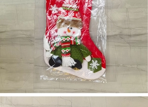 Detail of red Christmas stocking with 3D snowman doll decoration in retail packaging