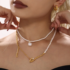 Elegant layered gold necklace with baroque pearls and matching hoop earrings for women