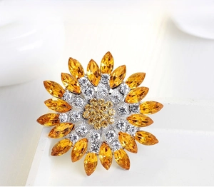 Close-up of sunflower brooch featuring yellow marquise crystals and white rhinestones