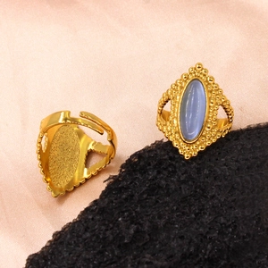 Vintage gold ring with oval blue gemstone and adjustable band on pink silk and stone