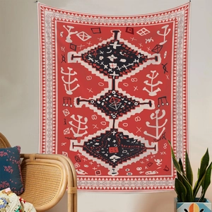 Close-up of bohemian red tapestry with tribal patterns in a cozy living room setup