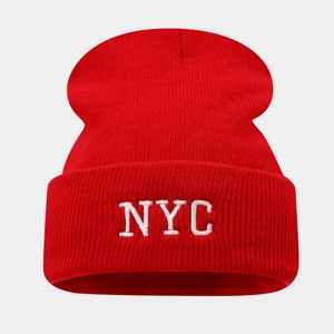 Détail de la broderie NYC blanche sur un bonnet en maille côtelée rouge à revers classique