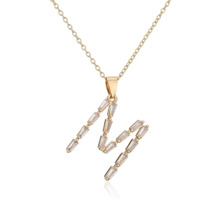 Close-up of 18K gold plated necklace with M-shaped pendant and inset cubic zirconia