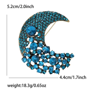 Fashion moon brooch with blue rhinestones and dimensions shown on white background