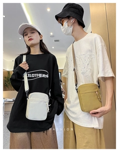 Detail of compact canvas crossbody phone bags in white and khaki for daily street style