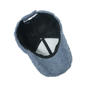 Detailed interior view of grey-blue plush baseball cap with warm fleece and cotton lining