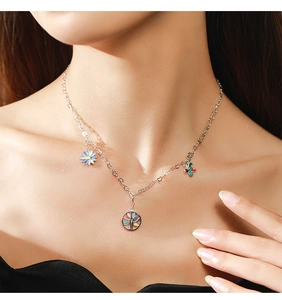 Detail of S925 silver necklace with tree of life and colorful enamel flower charms