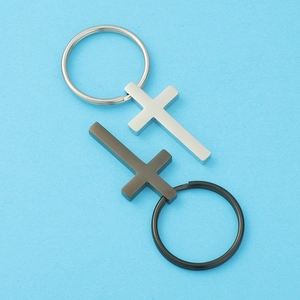 Detailed view of silver and black stainless steel cross keychains with mirrored finish