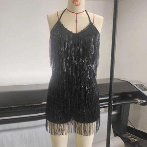Detail of black halter neck romper with dense flowing fringe and glossy satin finish