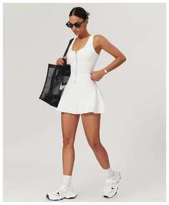 Detailed view of white sleeveless athletic dress featuring a zip neckline and A-line cut