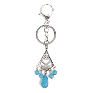 Detailed view of bohemian keychain with turquoise beads and vintage silver floral carvings