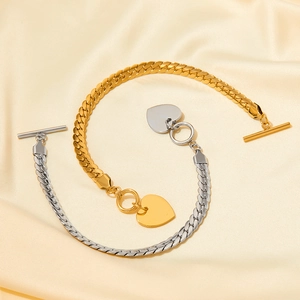 Two-tone heart charm bracelet with OT buckle on beige silk, minimalist jewelry