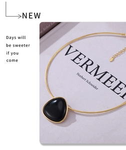 Detail of 18k gold plated snake chain necklace with a geometric black onyx pendant