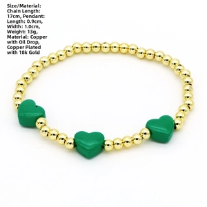 Detail of beaded gold chain bracelet with green enamel heart pendants and size specs
