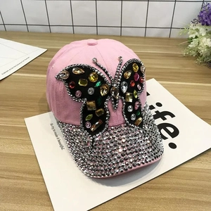 Close-up of pink baseball cap with colorful crystal butterfly and rhinestone brim detail