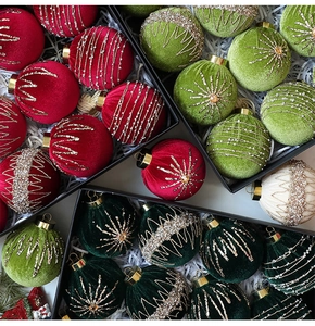Detailed macro view of velvet Christmas balls with glitter star patterns in gift box