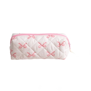 Pink quilted pencil case with bow pattern and zip closure on plain white background